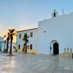 Church of Sant Francesc Xavier and main square with palm trees at sunset in Formentera, Balearic Islands