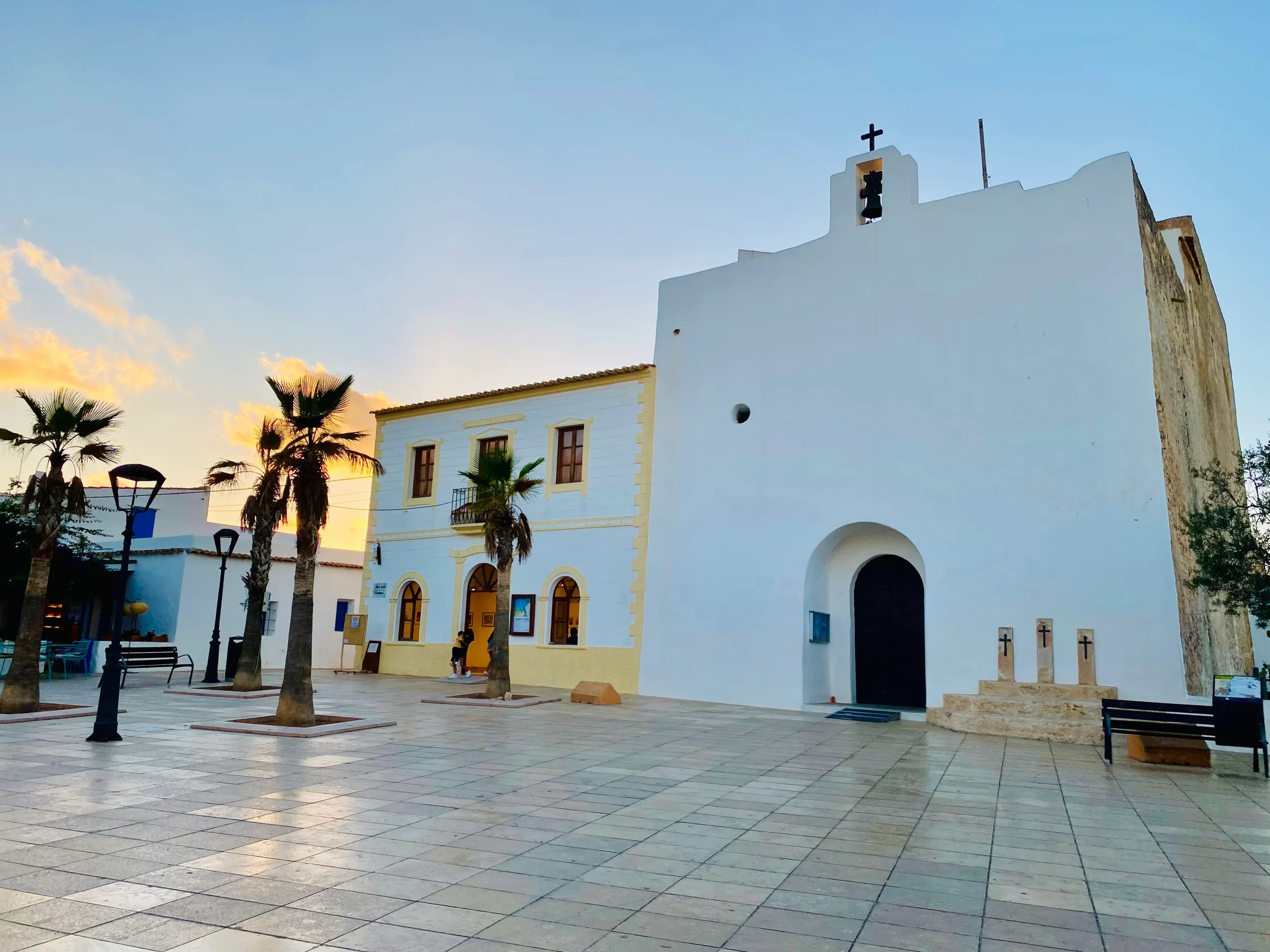 Church of Sant Francesc Xavier and main square with palm trees at sunset in Formentera, Balearic Islands
